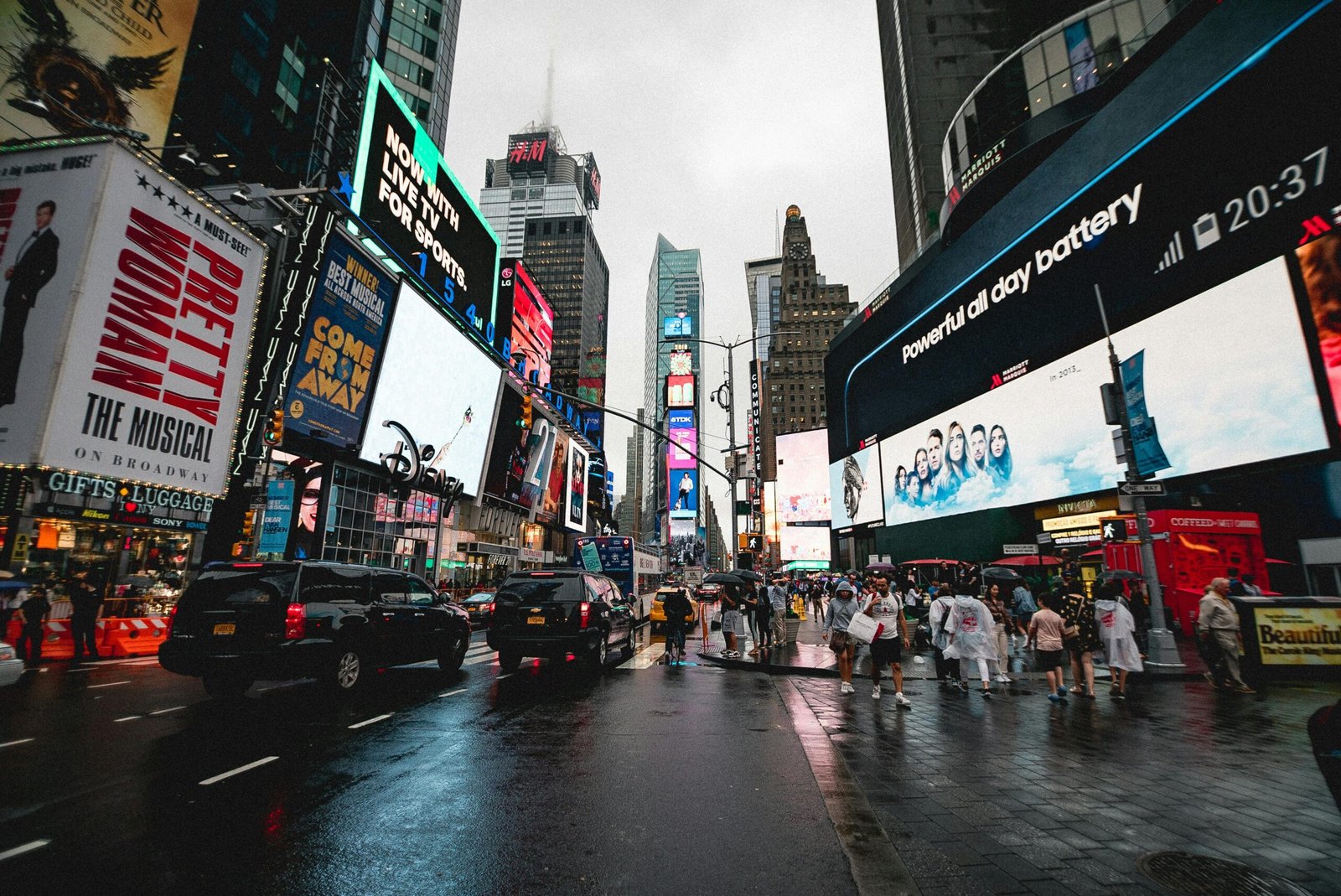 Night view of Times Square in NYC with illuminated billboards and a lively crowd.
