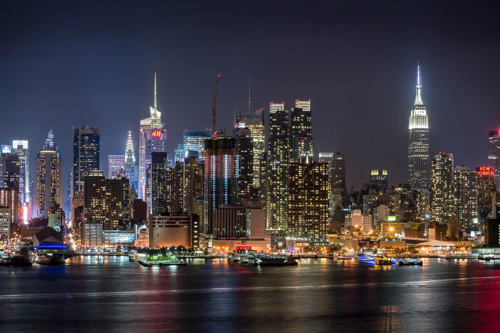 Aerial view of New York City skyline with iconic landmarks like the Empire State Building and One World Trade Center, highlighting NYC’s global corporate reputation.
