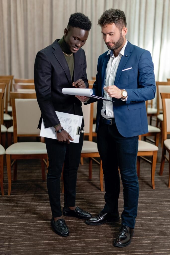 International corporate team planning a New York event with strategy discussion, charts, and laptops, guided by a professional NYC DMC.